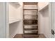 A walk-in closet with wooden shelves, providing ample storage space for clothing and accessories at 2119 E Sesame St, Tempe, AZ 85283