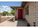 Charming brick home featuring a red security door and a desert-style front yard at 2119 E Sesame St, Tempe, AZ 85283