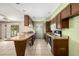 A kitchen featuring wood cabinets, a breakfast bar, and tile flooring, ready to be updated at 2119 E Sesame St, Tempe, AZ 85283