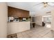 An open kitchen and dining area with wood cabinets and tile floors; a canvas for your dream renovation at 2119 E Sesame St, Tempe, AZ 85283