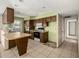 A kitchen ready for remodeling, with wood cabinets, a breakfast bar, and dated appliances at 2119 E Sesame St, Tempe, AZ 85283