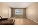 A living room featuring laminate flooring and a bright window with shutter-style blinds at 2119 E Sesame St, Tempe, AZ 85283