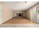 A living room showcasing a brick fireplace, sliding glass doors, and a combination of tile and wood flooring at 2119 E Sesame St, Tempe, AZ 85283
