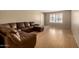 Spacious living room featuring hardwood floors and a comfortable, oversized leather sofa at 2119 E Sesame St, Tempe, AZ 85283