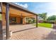 A spacious backyard with a large covered patio and brick pavers, ideal for outdoor entertaining and relaxation at 2124 W Harwell Rd, Phoenix, AZ 85041