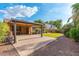 Beautiful backyard featuring a covered patio, brick pavers, green lawn, and well-maintained landscaping offering a perfect outdoor retreat at 2124 W Harwell Rd, Phoenix, AZ 85041