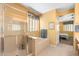 Bright bathroom features tile flooring, a glass shower and soaking tub, and an open doorway to the bedroom at 2124 W Harwell Rd, Phoenix, AZ 85041