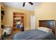 Simple bedroom featuring a bed, ceiling fan, closet, and open shelving unit at 2124 W Harwell Rd, Phoenix, AZ 85041