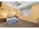 Spacious bedroom features neutral carpet, ceiling fan, and large window that provides lots of natural light at 2124 W Harwell Rd, Phoenix, AZ 85041