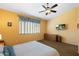 Bedroom features carpet, a ceiling fan, and a window with coverings; it includes a dresser and nightstand at 2124 W Harwell Rd, Phoenix, AZ 85041