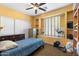 Relaxing bedroom with a comfortable bed, ceiling fan, and ample natural light from the window at 2124 W Harwell Rd, Phoenix, AZ 85041