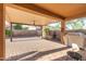 Large covered patio featuring brick pavers, a ceiling fan, and ample space for seating and outdoor enjoyment at 2124 W Harwell Rd, Phoenix, AZ 85041