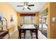 Inviting dining area features a sliding door to the outdoor patio, a ceiling fan, and a dark wood table at 2124 W Harwell Rd, Phoenix, AZ 85041