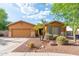 Charming single-story home featuring a well-manicured front yard and a two-car garage at 2124 W Harwell Rd, Phoenix, AZ 85041