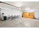 Spacious garage with epoxy flooring offers ample storage with cabinets and workspace for projects at 2124 W Harwell Rd, Phoenix, AZ 85041
