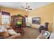 Spacious living room with plush sofas, a built-in entertainment center, and a ceiling fan at 2124 W Harwell Rd, Phoenix, AZ 85041