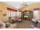 Warm living room with a plush brown sofa, built-in entertainment center, and a ceiling fan at 2124 W Harwell Rd, Phoenix, AZ 85041