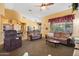Cozy living room with comfortable seating, a ceiling fan, and plenty of natural light at 2124 W Harwell Rd, Phoenix, AZ 85041