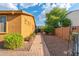 Charming side yard with brick pavers, desert landscaping, and a private walkway creating a welcoming outdoor space at 2124 W Harwell Rd, Phoenix, AZ 85041
