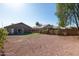 Exterior view of the back of a home with gravel and artificial turf at 22039 N 35Th Dr, Glendale, AZ 85310