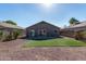 Exterior view of the back of a home with gravel and artificial turf at 22039 N 35Th Dr, Glendale, AZ 85310