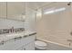 Bathroom with granite countertops, white cabinets and tiled shower over tub at 22039 N 35Th Dr, Glendale, AZ 85310