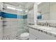 Stylish bathroom featuring mosaic tile floor, blue accent tiles, and granite countertops at 22039 N 35Th Dr, Glendale, AZ 85310