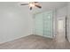 Bedroom featuring wood-look tile flooring, built-in shelving, and large closet at 22039 N 35Th Dr, Glendale, AZ 85310