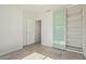 Bedroom with wood-look tile flooring, built-in shelving, and large closet at 22039 N 35Th Dr, Glendale, AZ 85310