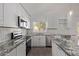 Beautiful kitchen with stainless steel appliances, granite countertops, and tile backsplash at 22039 N 35Th Dr, Glendale, AZ 85310