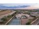 Expansive estate featuring a pool, tennis court, and lush landscaping in a serene desert setting at 3126 E Fruitvale Ct, Gilbert, AZ 85297