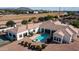 A sprawling, red rock desert home with a swimming pool, covered patio, and mature desert landscaping at 3126 E Fruitvale Ct, Gilbert, AZ 85297