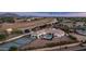 Aerial shot of home with a tennis court, a swimming pool, and lush landscaping at 3126 E Fruitvale Ct, Gilbert, AZ 85297