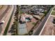 Drone shot overlooking a vast estate with mature trees, pool, and a tennis court at 3126 E Fruitvale Ct, Gilbert, AZ 85297