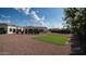 A backyard featuring mature landscaping, trees, and the back of the house with a covered arched patio at 3126 E Fruitvale Ct, Gilbert, AZ 85297