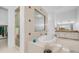 Elegant bathroom with shower, tub, and double vanity sink, plus walk-in closet access at 3126 E Fruitvale Ct, Gilbert, AZ 85297