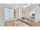 Luxurious bathroom with granite counters, soaking tub and vanity with large mirror at 3126 E Fruitvale Ct, Gilbert, AZ 85297