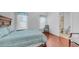 Bright bedroom with hardwood floors, a queen bed, and view to the bathroom at 3126 E Fruitvale Ct, Gilbert, AZ 85297