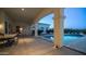 Inviting covered patio with elegant columns, an outdoor dining area, and a view of the sparkling pool at 3126 E Fruitvale Ct, Gilbert, AZ 85297