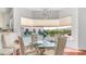 Cozy dining area with chandelier and a view of the backyard pool and landscaping at 3126 E Fruitvale Ct, Gilbert, AZ 85297