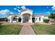 Inviting single-story home with manicured lawn and a brick pathway leading to the front entrance at 3126 E Fruitvale Ct, Gilbert, AZ 85297