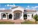 Close-up of a home's front entrance showcasing arched windows, brick walkway, and a custom front door at 3126 E Fruitvale Ct, Gilbert, AZ 85297