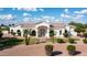 Attractive single-story home featuring beautiful masonry, arched windows, and mature palm trees at 3126 E Fruitvale Ct, Gilbert, AZ 85297