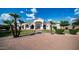 Attractive single-story home featuring mature landscaping, a brick driveway, and arched windows at 3126 E Fruitvale Ct, Gilbert, AZ 85297