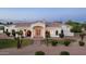Stunning single-story home boasts arched windows, a decorative front door, and mature landscaping at 3126 E Fruitvale Ct, Gilbert, AZ 85297