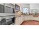 Gourmet kitchen features updated appliances, custom cabinetry, tiled backsplash, granite counters and a window for natural light at 3126 E Fruitvale Ct, Gilbert, AZ 85297