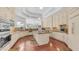 Spacious kitchen with white cabinets, granite countertops, stainless steel appliances, hardwood flooring, and modern lighting at 3126 E Fruitvale Ct, Gilbert, AZ 85297
