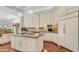 A large kitchen with an island, custom cabinets, granite countertops, and hardwood floors provides luxurious details at 3126 E Fruitvale Ct, Gilbert, AZ 85297