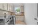 Convenient laundry room with ample cabinets, sink, and modern washer/dryer units at 3126 E Fruitvale Ct, Gilbert, AZ 85297
