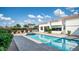 Backyard pool featuring a jacuzzi, tiled deck, and white exterior of the house, perfect for relaxation and outdoor enjoyment at 3126 E Fruitvale Ct, Gilbert, AZ 85297